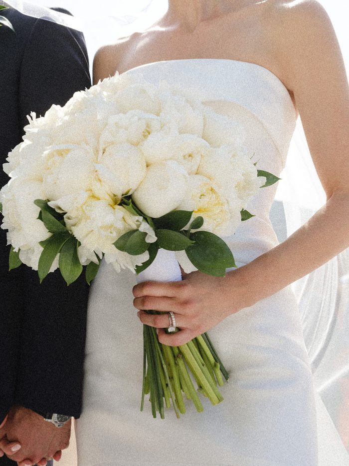 bride wearing veil holding bouquet and groom during ceremony decoration sea view seafront summer wedding in mykonos Greece at Alemagou ftelia classy classic designed by Only for you events